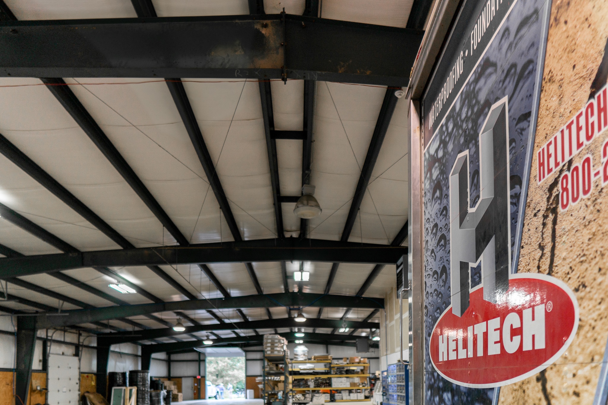 An inside view of a Helitech warehouse with a close up of a Helitech banner