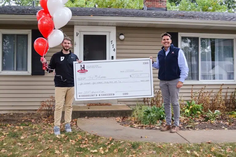 Jason with Burk Watts surprising him with a giant check