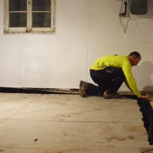 employee preventing basement leak