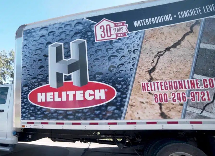 a helitech truck is parked on the side of the road