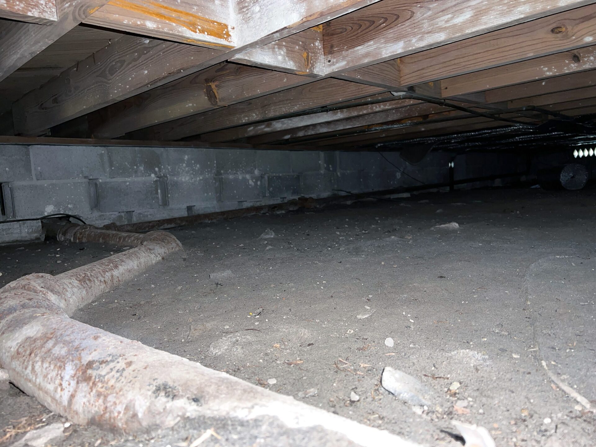 Pipe Running in Dirt Crawl Space Under House