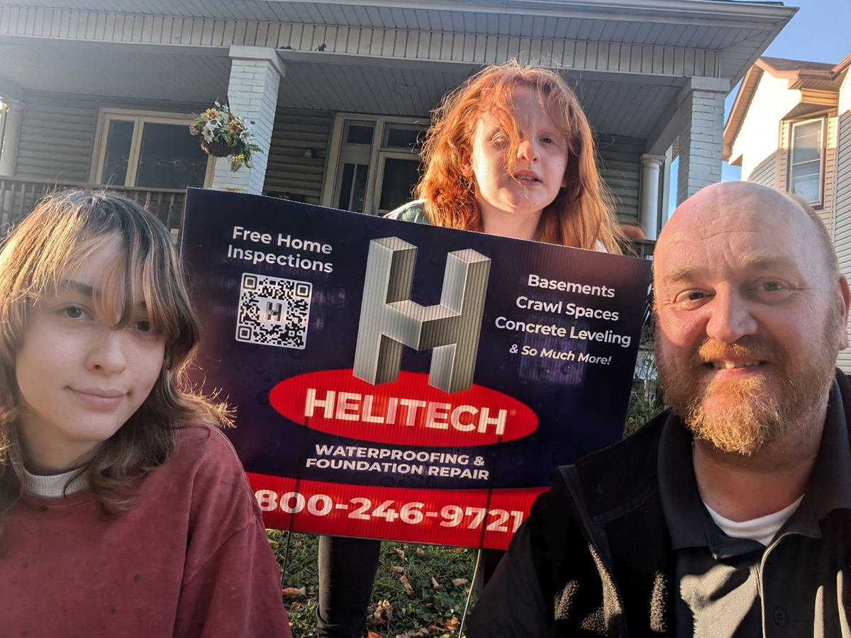 Family with Helitech Sign