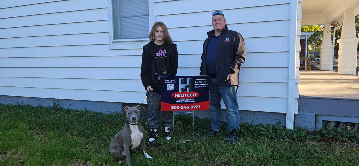 Family with helitech sign