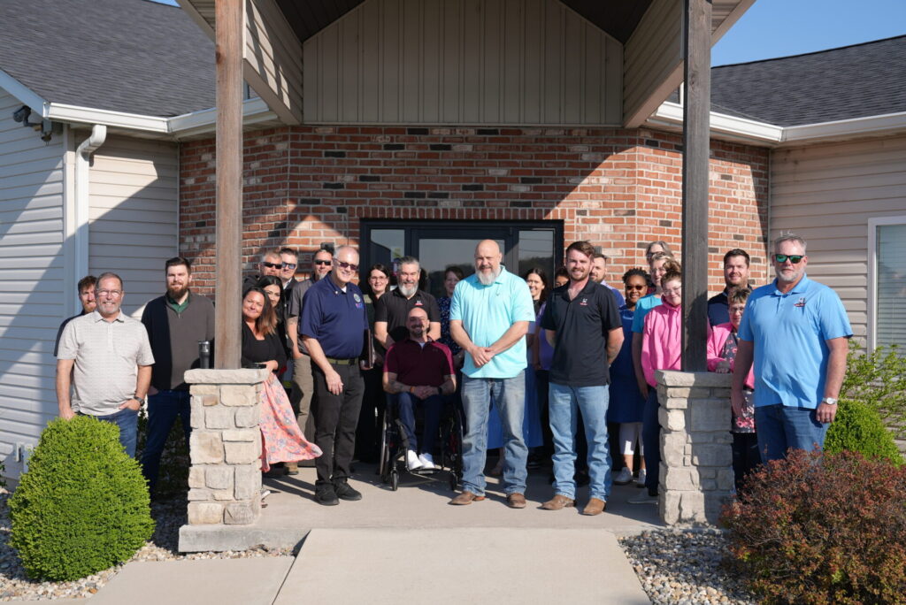 Helitech employees gather to congratulate John Voellinger on his award.